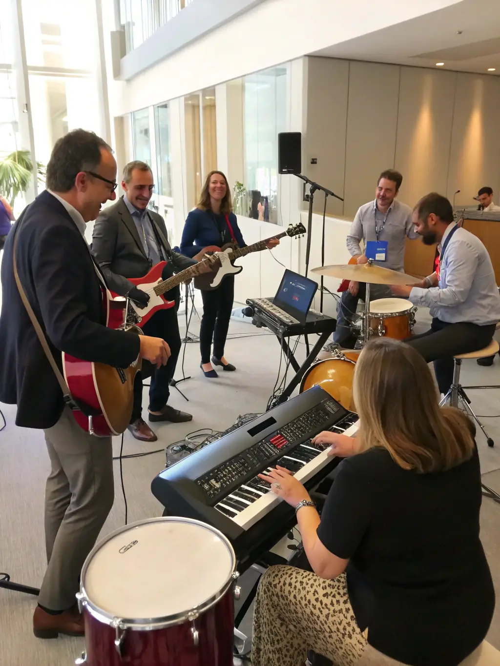 A group of people participating in a traditional music workshop, playing instruments and learning from an instructor, set in a cozy, culturally rich environment.